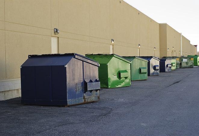 large garbage containers clustered on a construction lot in Greenlawn